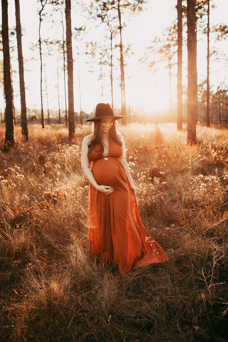 Orlando Family Photographer, pregnant woman in long dark orange dress and hat