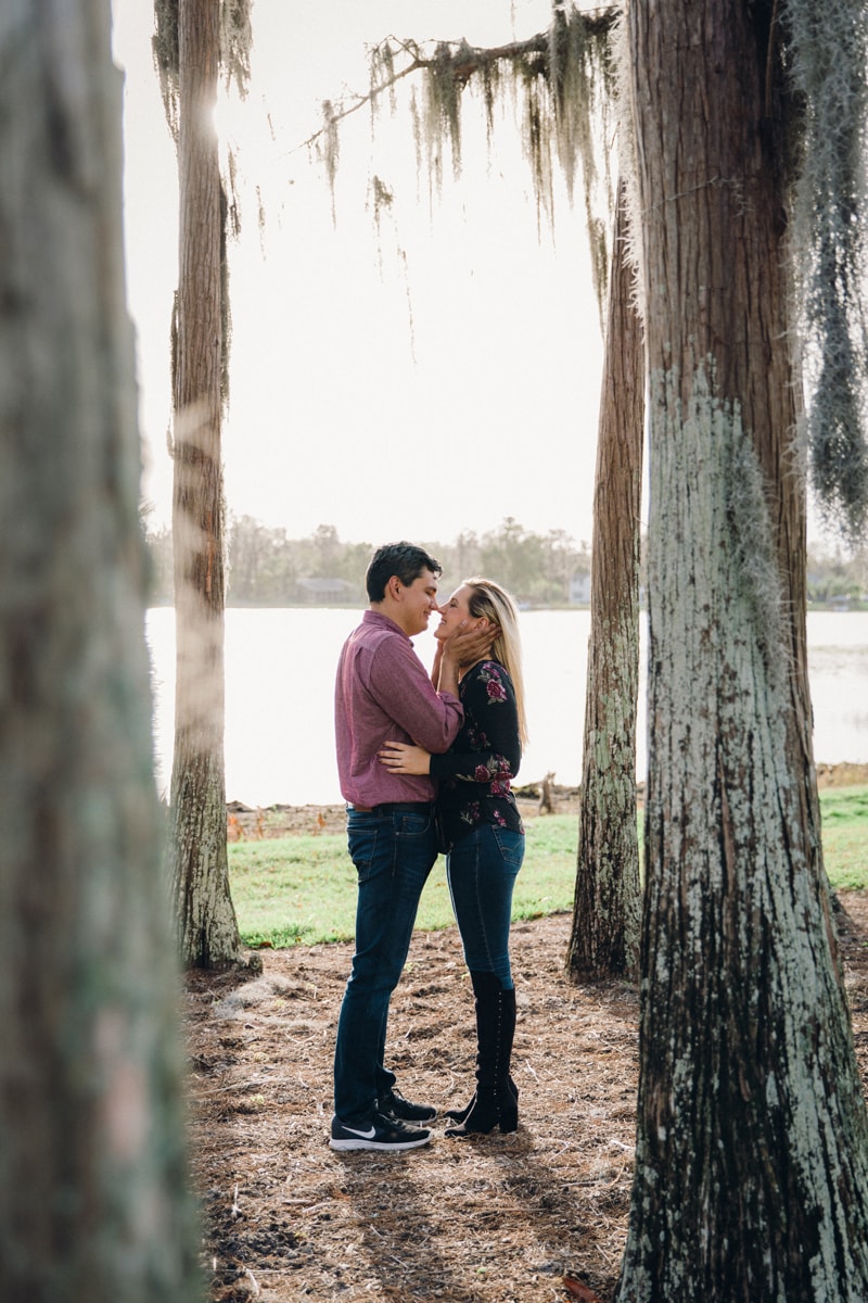 Orlando Couples Photography, couple standing between trees about to kiss