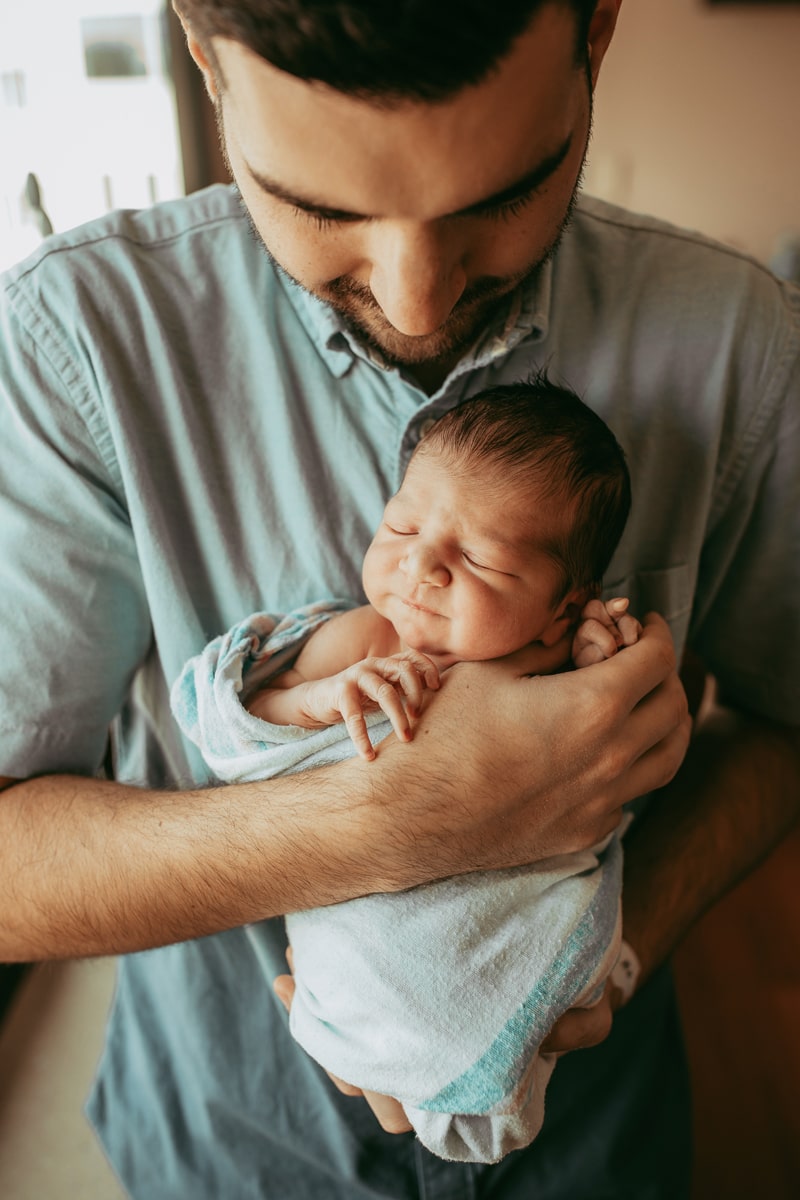 Orlando Fresh 48 Photographer, father holding baby outward toward camera