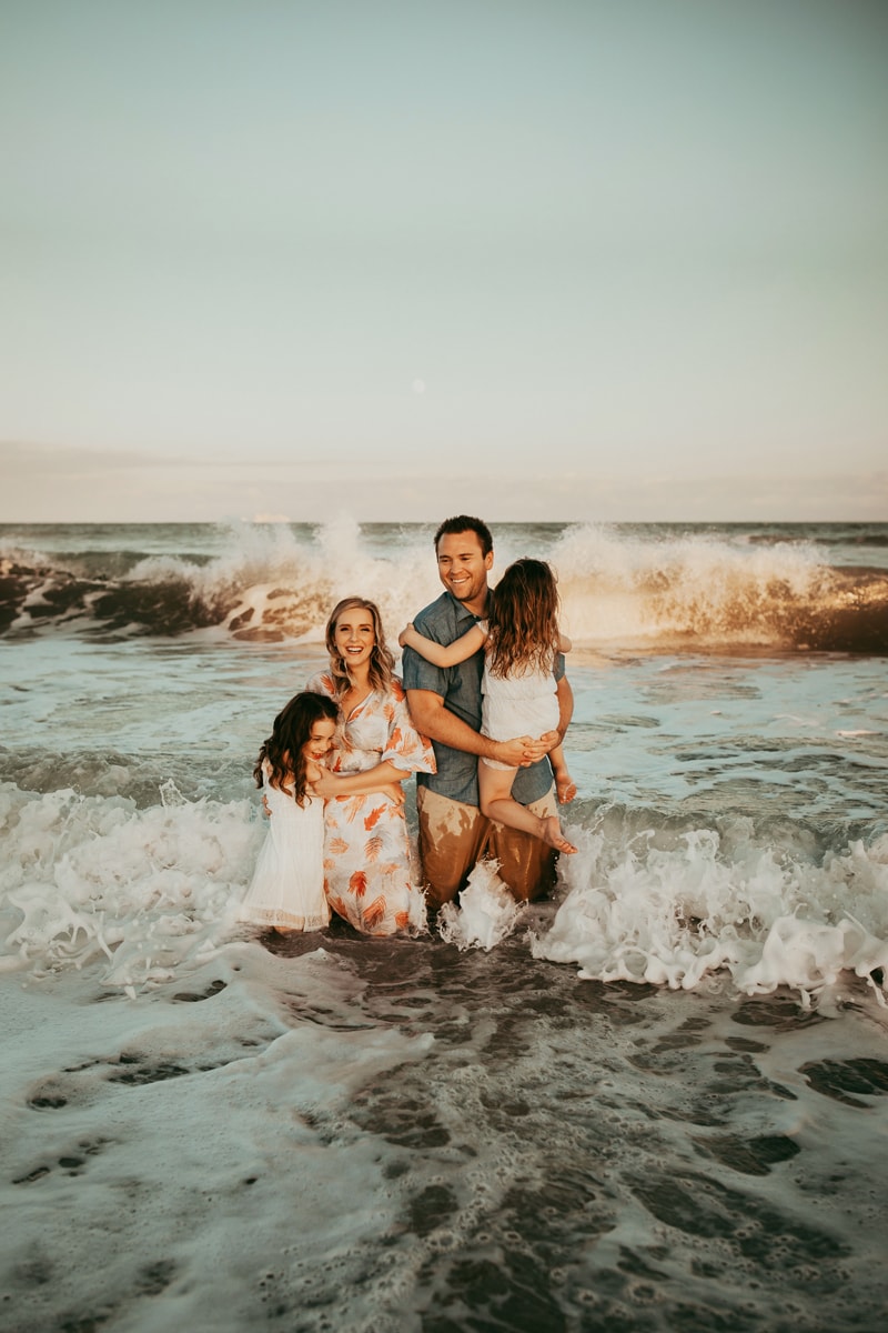 Orlando Family Photographer, family standing in the ocean water